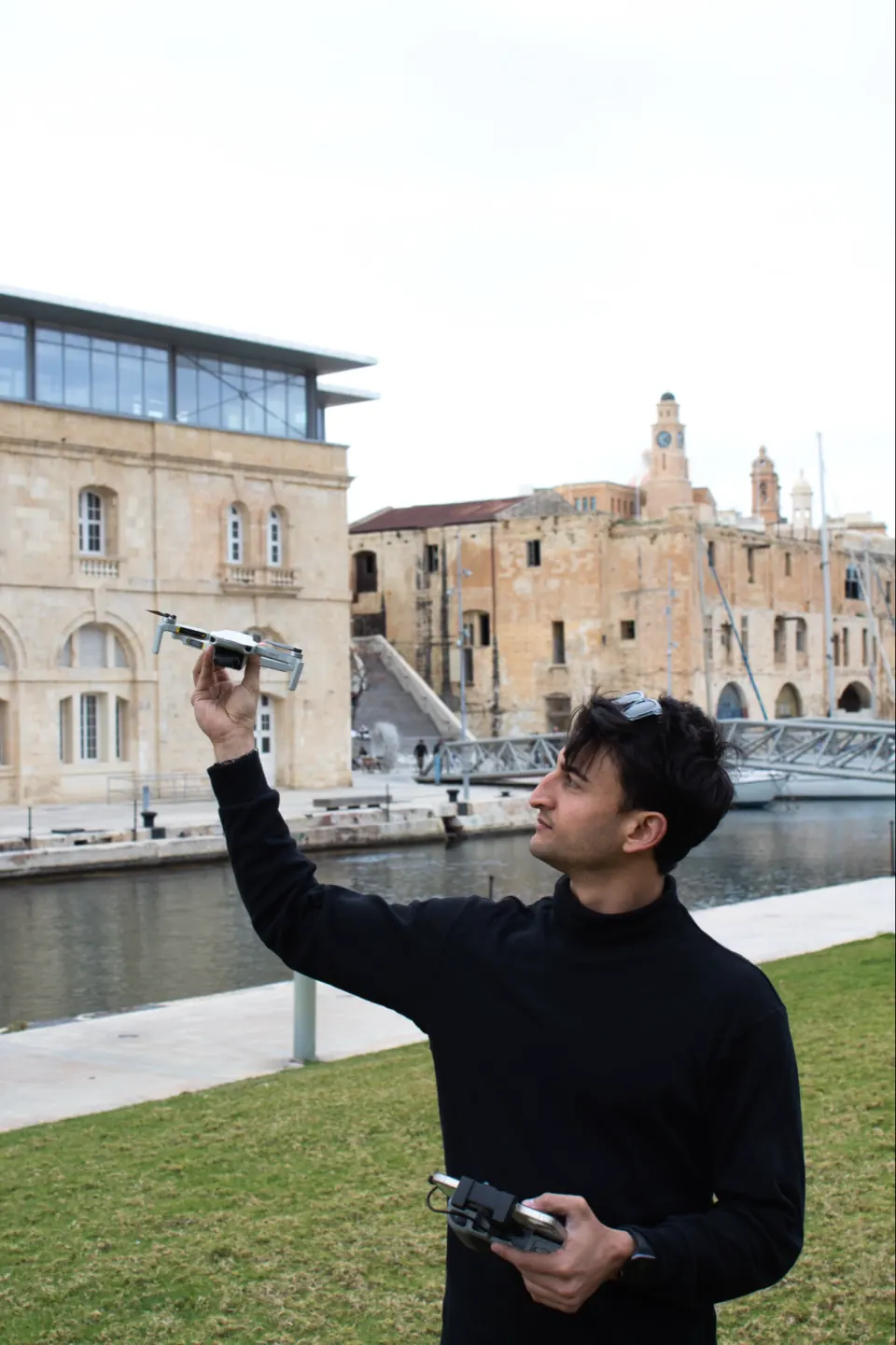 Giovanni flying a drone on the Birgu waterfront, Malta